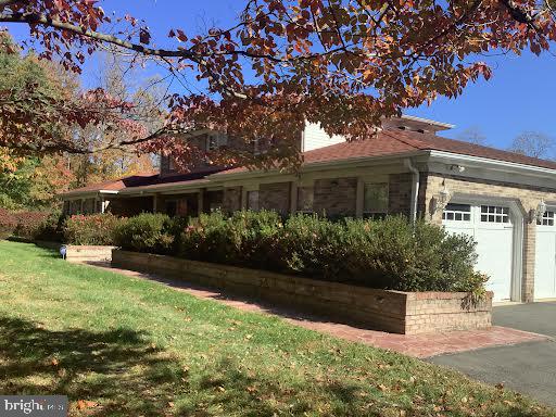 view of property exterior featuring a garage and a yard