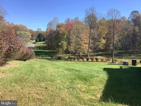 view of yard featuring central AC unit and a rural view