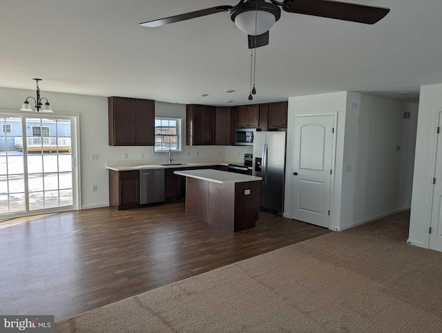 kitchen featuring a center island, stainless steel appliances, a wealth of natural light, and dark wood-type flooring