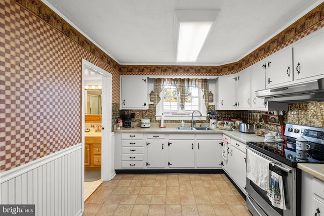 kitchen with sink, white cabinets, and stainless steel electric stove