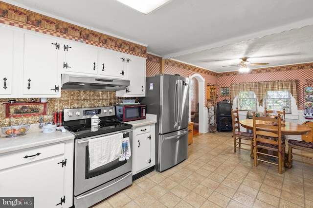 kitchen featuring appliances with stainless steel finishes, white cabinets, backsplash, and ceiling fan