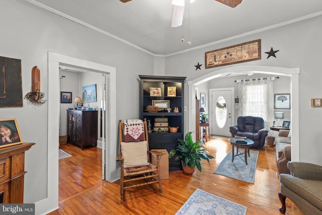 living room featuring ornamental molding, hardwood / wood-style flooring, and ceiling fan