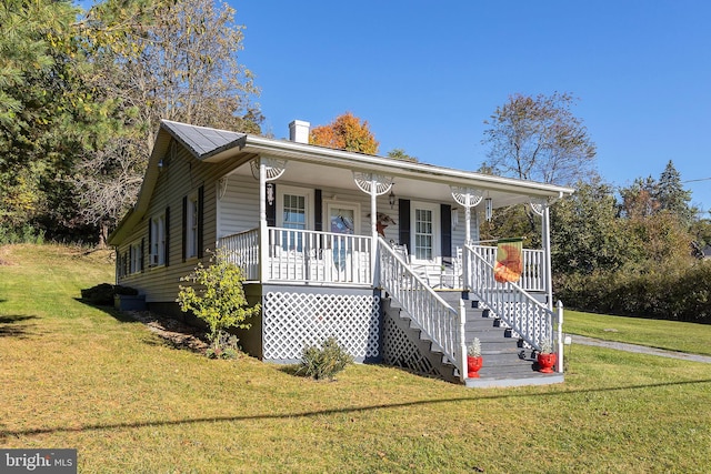 bungalow-style house featuring a front yard and covered porch