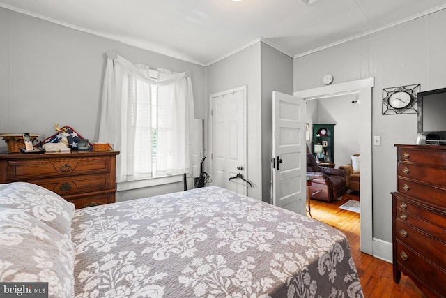 bedroom featuring ornamental molding and wood-type flooring