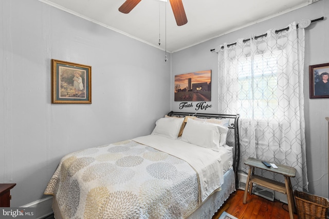 bedroom with ceiling fan, crown molding, and dark hardwood / wood-style flooring