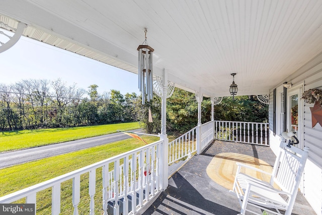 exterior space featuring a lawn and a porch