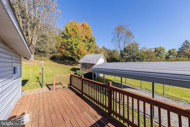 wooden terrace with a yard and a storage shed