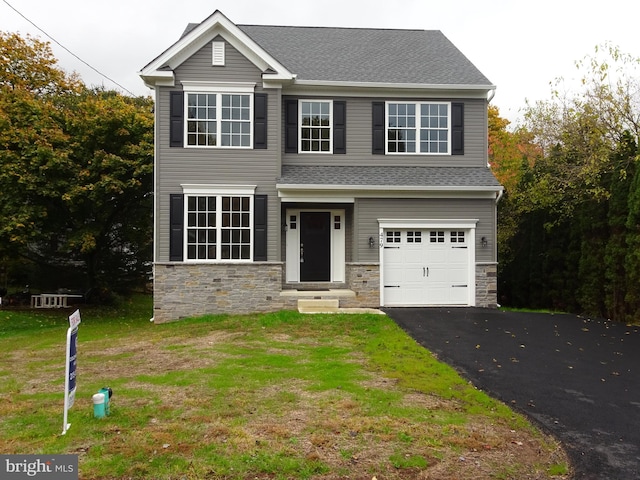 view of front of house with a front lawn and a garage