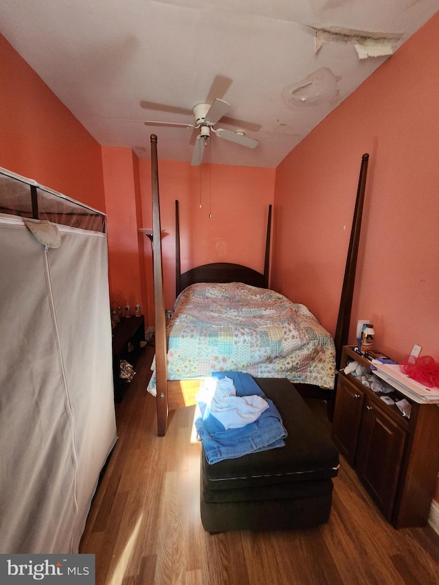 bedroom with ceiling fan and hardwood / wood-style flooring