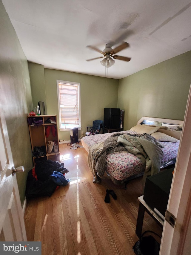 bedroom featuring ceiling fan and light hardwood / wood-style flooring