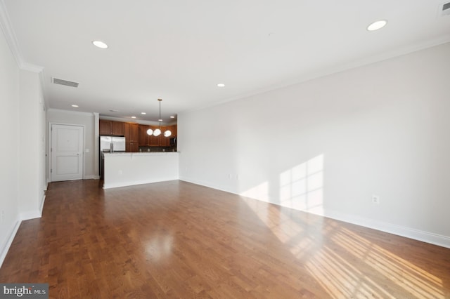 unfurnished living room with dark wood-type flooring and ornamental molding