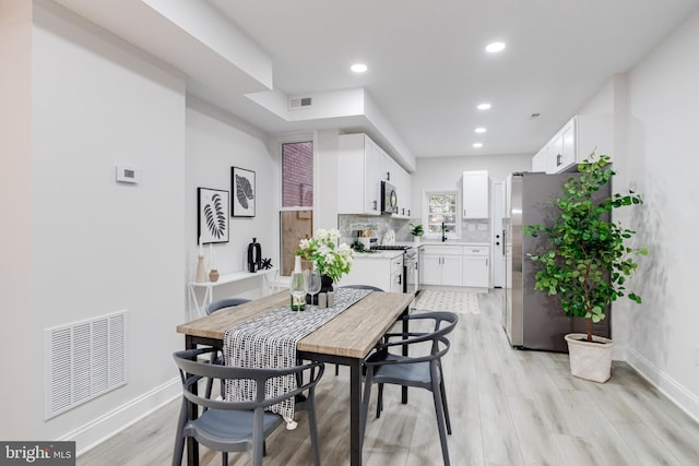 dining space featuring light hardwood / wood-style floors