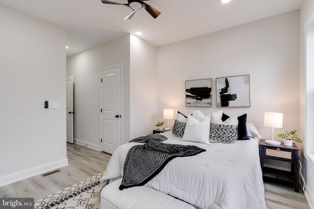 bedroom with light wood-type flooring and ceiling fan