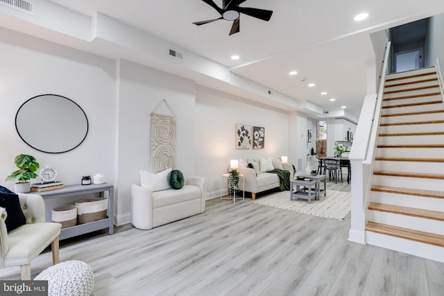 living room featuring ceiling fan and light wood-type flooring