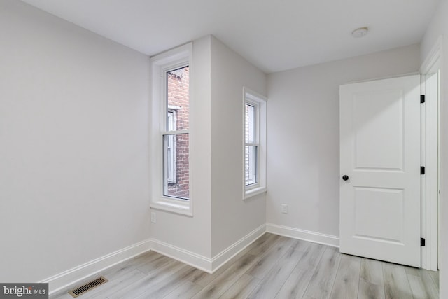 unfurnished room with light hardwood / wood-style flooring