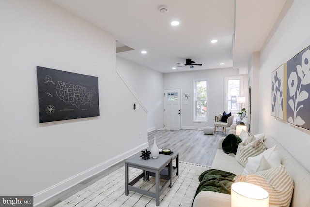 living room featuring light wood-type flooring and ceiling fan