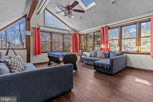 interior space featuring ceiling fan, vaulted ceiling with skylight, and billiards