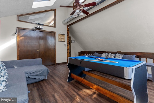 game room with dark wood-type flooring, vaulted ceiling with skylight, billiards, a textured ceiling, and ceiling fan