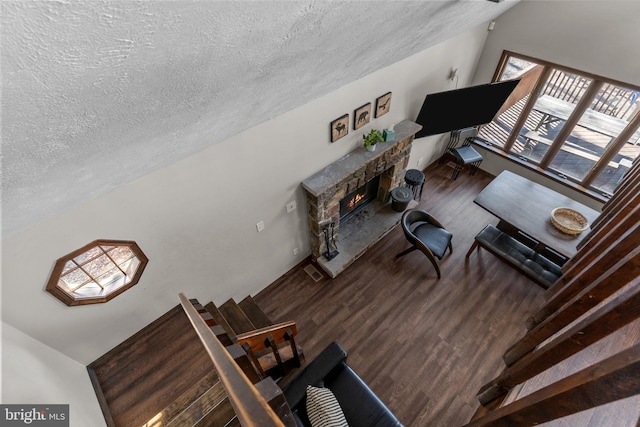 living room with a textured ceiling, wood-type flooring, and plenty of natural light