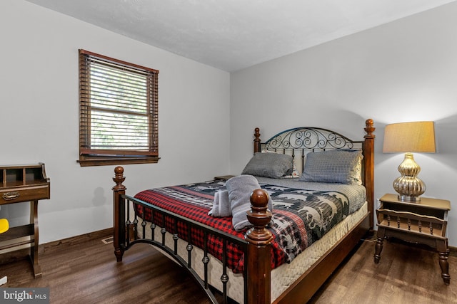 bedroom with hardwood / wood-style flooring