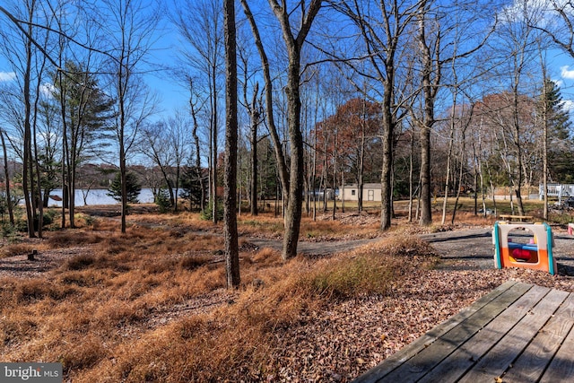 view of yard featuring a deck with water view