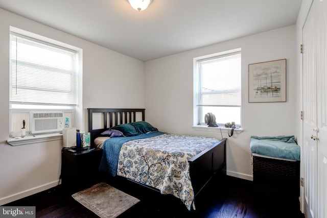 bedroom featuring cooling unit, multiple windows, and dark hardwood / wood-style flooring