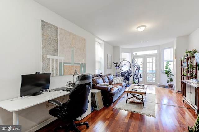 office area with french doors and hardwood / wood-style flooring