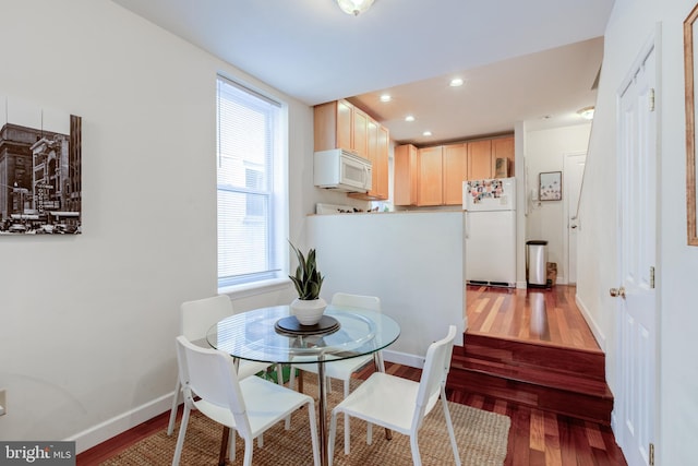 dining space with hardwood / wood-style flooring