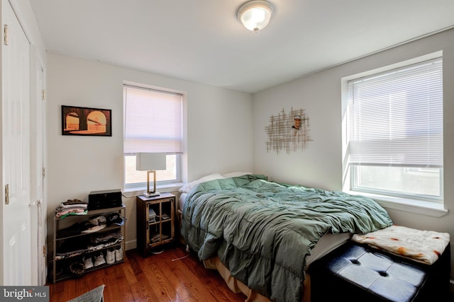 bedroom with dark hardwood / wood-style floors