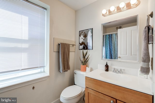 bathroom with toilet and vanity