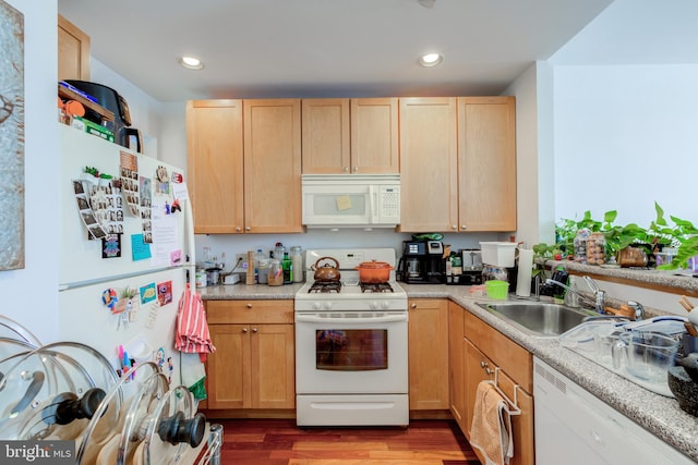 kitchen with white appliances, wood-type flooring, sink, and light brown cabinets