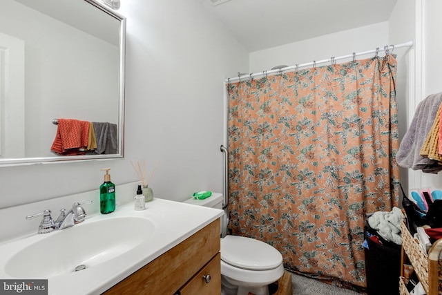 bathroom featuring vanity, a shower with curtain, and toilet