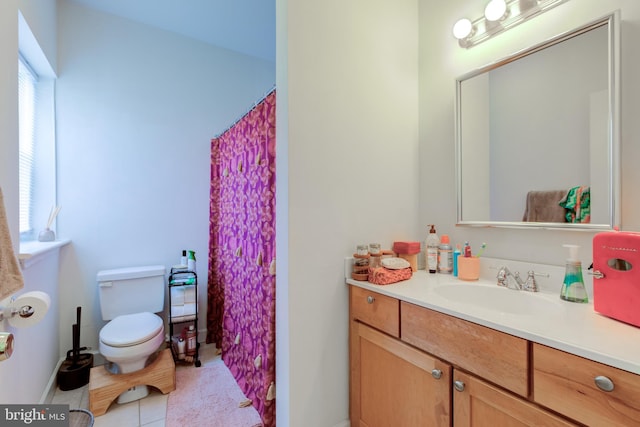 bathroom with vanity, toilet, and tile patterned flooring