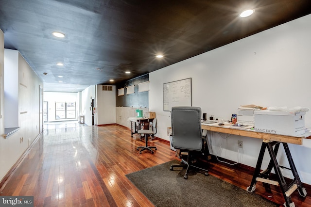 office area with built in desk and wood-type flooring