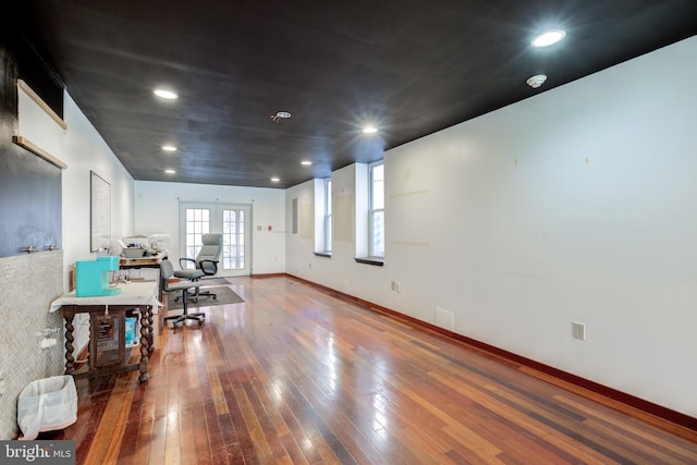 interior space with french doors and hardwood / wood-style floors