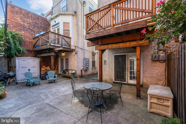 view of patio / terrace featuring a balcony and a storage unit