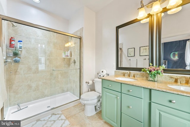 bathroom featuring toilet, vanity, tile patterned floors, and an enclosed shower