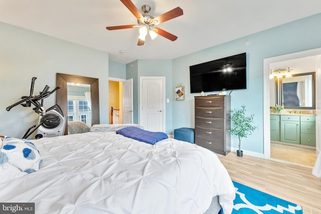 bedroom with ensuite bathroom, ceiling fan, and light hardwood / wood-style floors