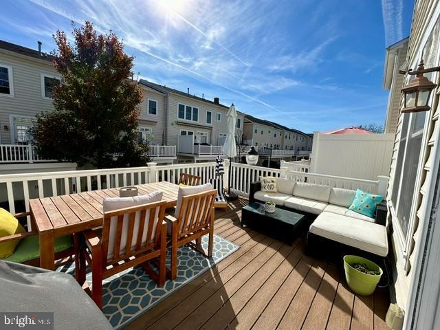 wooden terrace with an outdoor hangout area