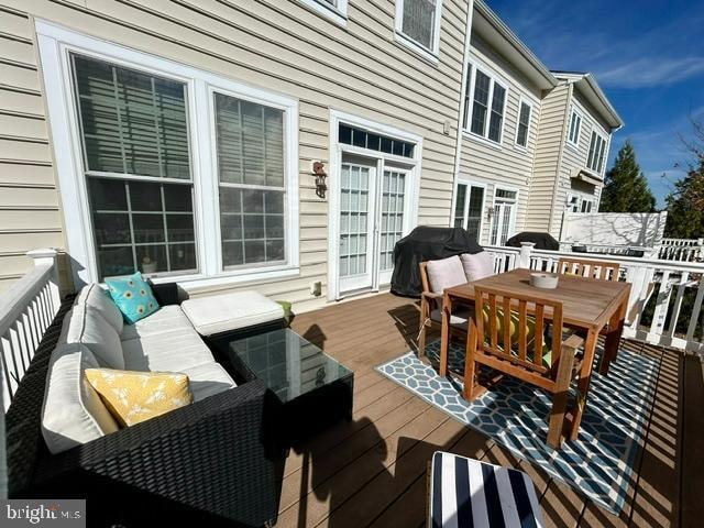 wooden terrace featuring a grill