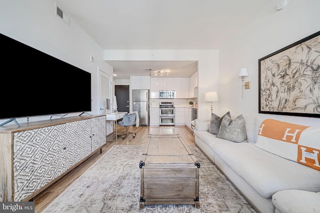 living room with light hardwood / wood-style flooring