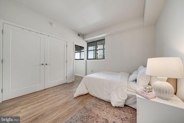 bedroom featuring light hardwood / wood-style flooring and a closet