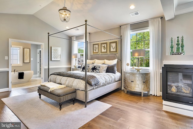 bedroom with lofted ceiling and hardwood / wood-style floors