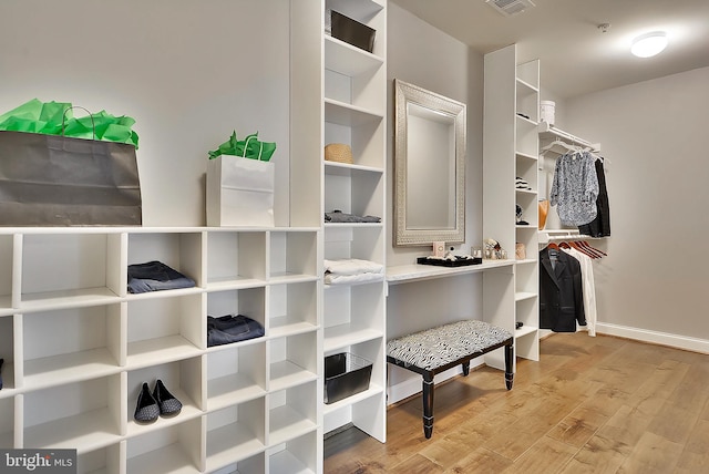 walk in closet featuring light hardwood / wood-style flooring