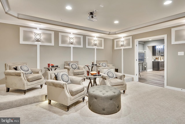 cinema room featuring crown molding and light carpet