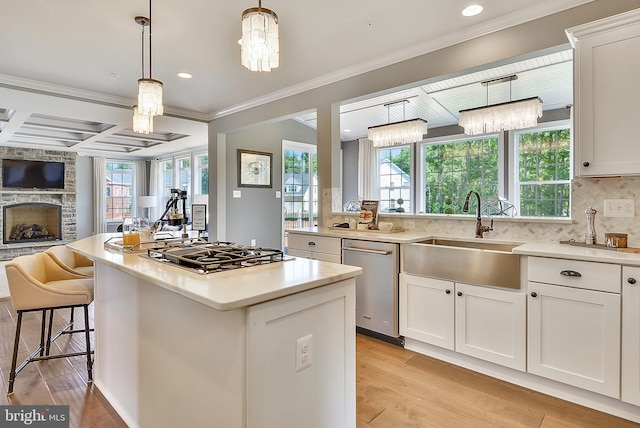 kitchen featuring sink, white cabinetry, stainless steel appliances, and light wood-type flooring