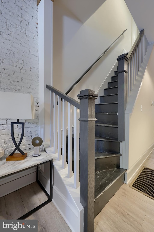 stairs featuring hardwood / wood-style flooring