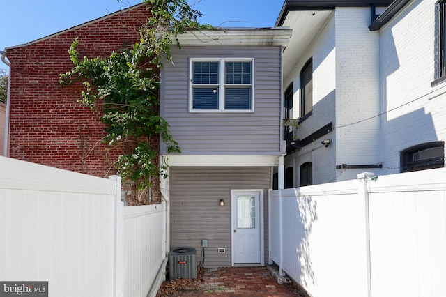 back of property featuring cooling unit