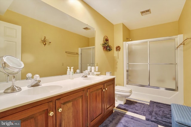 full bathroom with shower / bath combination with glass door, toilet, and vanity