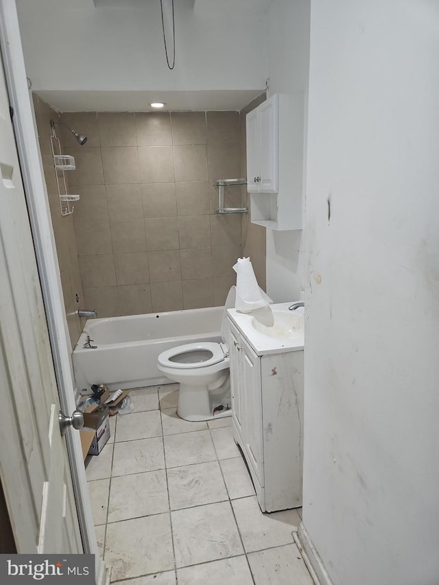 full bathroom featuring tile patterned flooring, vanity, toilet, and tiled shower / bath